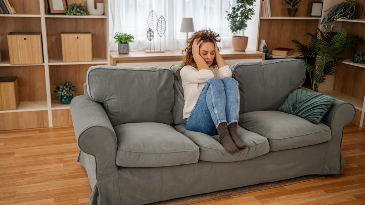 Woman on couch stressed